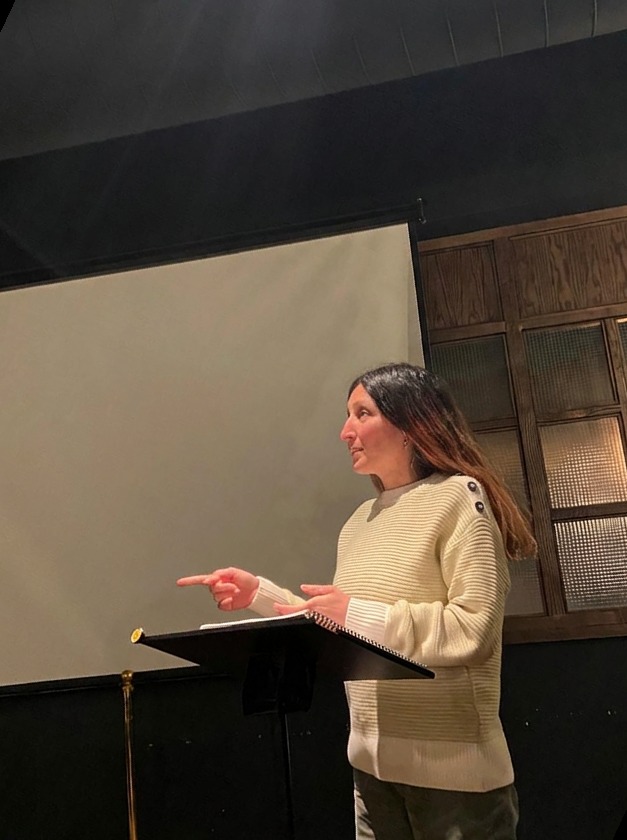 A member speaking from a lectern during a session